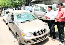 Officials challan cars parked on the roadside before removing these at Phase I, Industrial Area, Chandigarh, on Wednesday