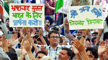 Supporters of Anna Hazare protest against the police crackdown on Baba Ramdev and his followers, at Rajghat in New Delhi on Wednesday. 