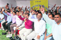 Ameens of the Revenue Department hold a protest in Dehradun on Wednesday