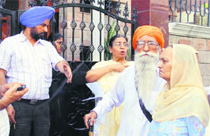 Officials of the district administration escort an aged couple to their sons house in Amritsar 