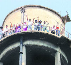Protesters atop a water tank.