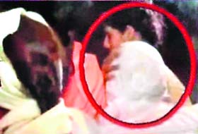CRACKDOWN ACCOUNT: A TV grab shows Baba Ramdev (in red circle) being taken away by his women supporters at the Ramlila Maidan in New Delhi on Saturday night