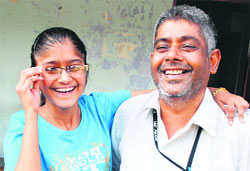 Sonia, who secured 92.6 per cent in commerce stream, with her father. @@