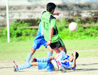 Players try to take control of the ball in a match in the Lala Nemi Dass Memorial District Football League played at the Pavilion ground in Dehradun on Thursday. 