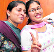 Bhavna Gupta, who secured third position in the Punjab PMT, poses with her sister in Mullanpur on Thursday.