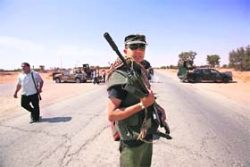 Libyan rebel fighters hold a checkpoint near Misrata's eastern frontline on Thursday