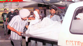 The victims body being taken to an ambulance at Phase X, Mohali, on Friday.