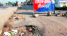 Barricades placed on the newly built service road, which had sunk, along the Chandigarh-Ambala highway.