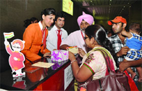 Passengers check in at the Air India counter at the New Delhi Metro Airport station which became operational on Friday.