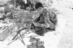 A rebel fighter cleans his automatic weapon at the Bir Ayyad gate near the city of Zintan in the Western Mountains, some 120 km southwest of the capital Tripoli, on Thursday