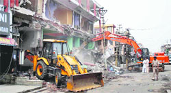 JCB machines demolish a portion of a commercial complex in Faridabad on Friday.