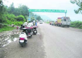 Fuelling anxiety: Consumers wait for the LPG delivery vehicle along the road near Sundernagar