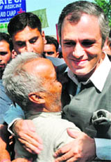 Chief Minister Omar Abdullah hugs a Kashmiri Pandit during his visit to Khir Bhawani Temple at Tullmulla in Ganderbal.