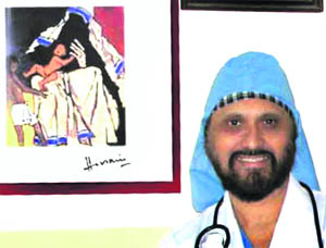 Dr HS Bedi alongside a painting MF Hussain made for him. 