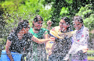 Girls enjoy the pleasant weather with a splash of water at PAU in Ludhiana. 