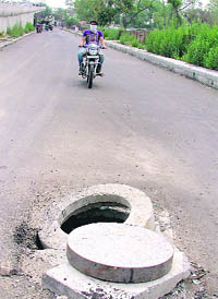 An open manhole near Lakkar bridge flyover in Ludhiana. No lessons seem to have been learnt from the recent incident when a nine-year-old lost his life.