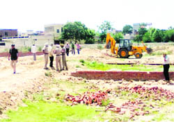 An illegal colony near a railway line in Dugri being demolished
