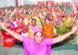 Members of the Mid-Day Meal Workers Union stage a dharna at Desh Bhagat Yadgaar Hall in Jalandhar on Sunday