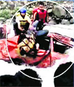Rescuers take out a man from a car which fell into the Lidder Nullah in Pahalgam on Friday