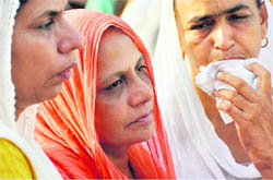 Rajpal Kaur (centre) at the cremation of her husband ASI Gurdial Singh in Ludhiana on Sunday.