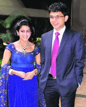 Infosys chairman NR Narayan Murthy's son Rohan with his wife Lakshmi Veny posing for photographs after their wedding reception in Bangalore on Sunday