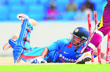 Subramaniam Badrinath (L) dives to save his wicket in the 3rd ODI in Antigua on Saturday