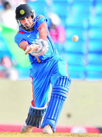 Top Shot: Rohit Sharma hits a boundary to score the winning runs during the third one-day international against the West Indies at the Sir Vivian Richard Stadium in St John's on Saturday. India defeated the West Indies by three wickets to take a 3-0 lead of the five match ODI series