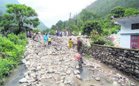 A road littered with debris and boulders following a cloudburst in Choribagar area of Pithoaragarh district on Sunday.