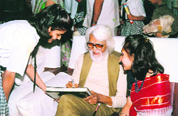 MF Hussain signing autographs for students of Vidya Devi Jindal School for Girls at Hisar in 1994. 