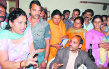 Members of an NGO grill its director (sitting) in Mandi on Monday. 