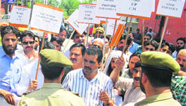 Cross-LoC traders hold a protest in Srinagar on Monday in support of their demand for an increase in the number of items on the trade list.