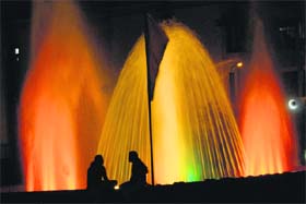 COLOURFUL SPLASH Girls enjoy beside a colourful fountain installed by municipal corporation at Sector 48 in Chandigarh on Tuesday