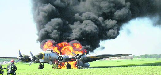 A World War II-era B-17 bomber is engulfed in flames after making what appeared to be an emergency landing in a cornfield in Oswego, US