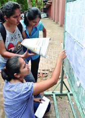 Students check the first cut-off list at DU on Wednesday