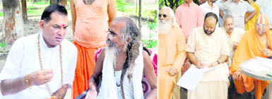 Swami Shivanand, the founder of Matra Sadan, Brahamswaroop Brahamchari Jagadguru Swami Hansvedacharya and saints ink their thoughts on a register to be sent as a memorandum to the Central Government, in Haridwar 
