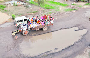 Road turns Into pond: Water lies collected on a stretch of the Moga road in Shahkot. These water-filled stretches hit traffic flow and pose danger to commuters