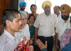 Raffiq-ul-Islam, the teenager from Bangladesh, who had accidentally strayed into India, with Minister for Social Welfare Laxmi Kanta Chawla and other officials at the juvenile home in Faridkot on Thursday.