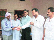 OP Sharma, Naraingarh SDM, hands over a cheque to the family of a youth who died in an accident near Gadhauli village.