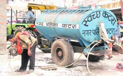 A tanker of the Municipal Corporation, Katra, supplies drinking water at the bus stand