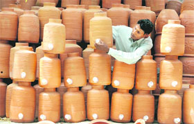A potter fits tap to an earthen titcher in Jalandhar. 