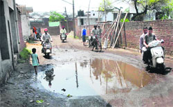 A broken link road in Gadaipur in Jalandhar with stagnant water posing problems for commuters.