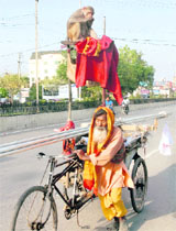 A monkey enjoys a ride on a rickshaw in Jalandhar. 
