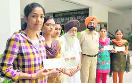 Students, who were awarded scholarships, whith their cheques in Ludhiana. 