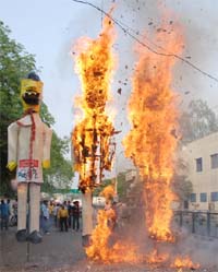 Residents burn effigies of UPA chairperson Sonia Gandhi, Prime Minister Dr Manmohan Singh and former cabinet minister A Raja in protest against rising corruption in the country, in Bathinda