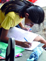 An aspirant fills in her form at a college in Delhi University on Friday
