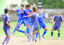 Players struggle to take control of the ball in a match of the Lala Nemi Dass Memorial District Football League at the Pavilion ground in Dehradun on Friday