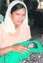Inconsolable Kiran with her dead baby at the Rohtak PGIMS on Friday