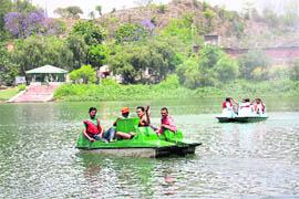 Tourists enjoy a boat ride in Mansar Lake in Udhampur on Friday. 