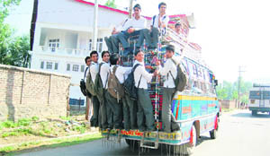 In the absence of adequate transport facility in most areas of Kashmir, students have to travel on buses in a risky manner
