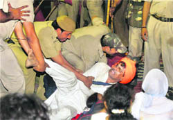 Policemen evict a Ramdev supporter from Delhis Ramlila Maidan on the night of June 4-5.